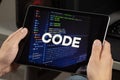 a male hands holding a tablet with the phrase code over a writing code concept Royalty Free Stock Photo