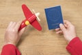 Male hands with a plane and passport Royalty Free Stock Photo