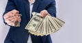 Male hands holding US dollars bills and house key isolated Royalty Free Stock Photo