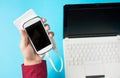 Male hands holding a white cellphone connected to a power bank Royalty Free Stock Photo