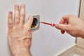 male hands installing electrical wall outlets with a screwdriver Royalty Free Stock Photo