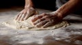 Male hands kneading dough on a wooden table in a bakery. Royalty Free Stock Photo