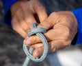 Male hands with knotted rope