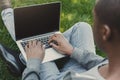 Male hands with laptop, over shoulder shot outdoors