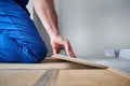 Male worker hands laying laminate flooring in apartment. Royalty Free Stock Photo