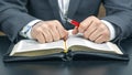 Male hands lie on an open holy bible close up. the search for God and the study of the book