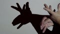 Male hands make the shadow of the elk under the projector lighting Entertainment theater for young children Royalty Free Stock Photo