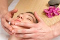 Male hands of the masseur, cosmetologist, doing massage the girl Royalty Free Stock Photo