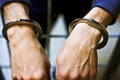 Male hands in metal handcuffs closeup. A prisoner in jail. the concept of punishment for a crime