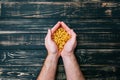In male hands, pasta on black wooden background Royalty Free Stock Photo
