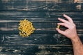 In male hands, pasta on black wooden background Royalty Free Stock Photo