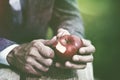 male hands peeling apple with knife