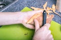 Male hands peeling sweet potatoes Royalty Free Stock Photo