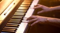 Male hands on the piano keys closeup of a beautiful colorful background Royalty Free Stock Photo