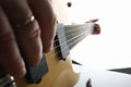 Male hands playing electric guitar on maple fretboard Royalty Free Stock Photo