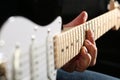 Male hands playing electric guitar on maple fretboard Royalty Free Stock Photo