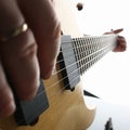 Male hands playing electric guitar on maple fretboard Royalty Free Stock Photo