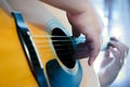 Male hands playing fingers style on a western dreadnought guitar in blue neon light Royalty Free Stock Photo