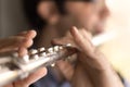 Male hands playing a flut.