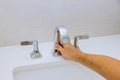 Male hands plumber fixing a faucet of a sink in bathroom Royalty Free Stock Photo