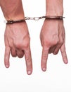 Male hands in police handcuffs showing gesture isolated Royalty Free Stock Photo