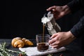 Pouring coffee from an italian percolator, shot in low key