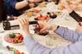 male hands pour wine. large festive table. Bottle of wine