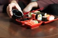 Male hands pours sauce in a plate. Sushi set Royalty Free Stock Photo