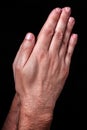 Male hands praying with palms together. Black background. Royalty Free Stock Photo