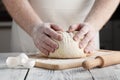 Male hands preparing dough for pizza on table closeup Royalty Free Stock Photo