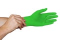 Male hands putting on green medical gloves isolated on white background Royalty Free Stock Photo