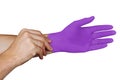 Male hands putting on violet medical gloves isolated on white background Royalty Free Stock Photo