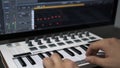 Male hands recording midi keyboard in sequencer in computer in home studio Royalty Free Stock Photo