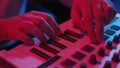 Male hands recording music using midi keyboard in home studio, neon lights Royalty Free Stock Photo