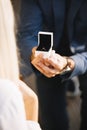 male hands with red velvet box containing engagement ring. High quality photo Royalty Free Stock Photo