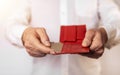 Male hands with red wallet and golden bank plastic card close up