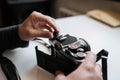 Male hands reloading film retro camera on a white table Royalty Free Stock Photo