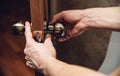 Male hands repairman fix a door handle