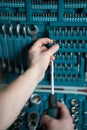 Male hands select screwdriver tip Royalty Free Stock Photo
