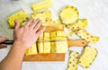 Male hands slicing pineapple fruit on a board Royalty Free Stock Photo