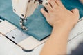 Male hands tailor working on sewing machine, making shopper bag from fabric