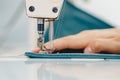 Male hands tailor working on sewing machine, making shopper bag from fabric