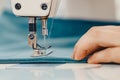 Male hands tailor working on sewing machine, making shopper bag from fabric