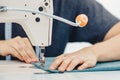 Male hands tailor working on sewing machine, making shopper bag from fabric