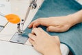 Male hands tailor working on sewing machine, making shopper bag from fabric