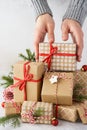 Male hands taking a gift box from a big stack of gifts