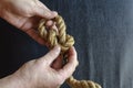 Male hands tie a knot on a rope Royalty Free Stock Photo