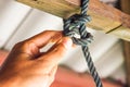 Male hands tie a rope tree,Rope knot line tied together with nature background,as a symbol for trust Royalty Free Stock Photo