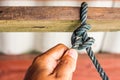 Male hands tie a rope tree,Rope knot line tied together with nature background,as a symbol for trust Royalty Free Stock Photo