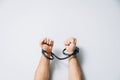 Male hands tied by a metal chain. Day of the struggle for the abolition of slavery. Royalty Free Stock Photo